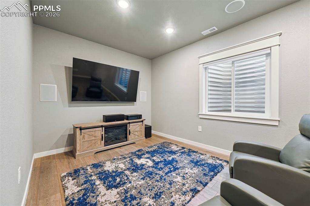 15945 Little Bluestem Road Monument, CO 80132 - Photo 29 of 49 a living room with a flat screen tv and a couch
