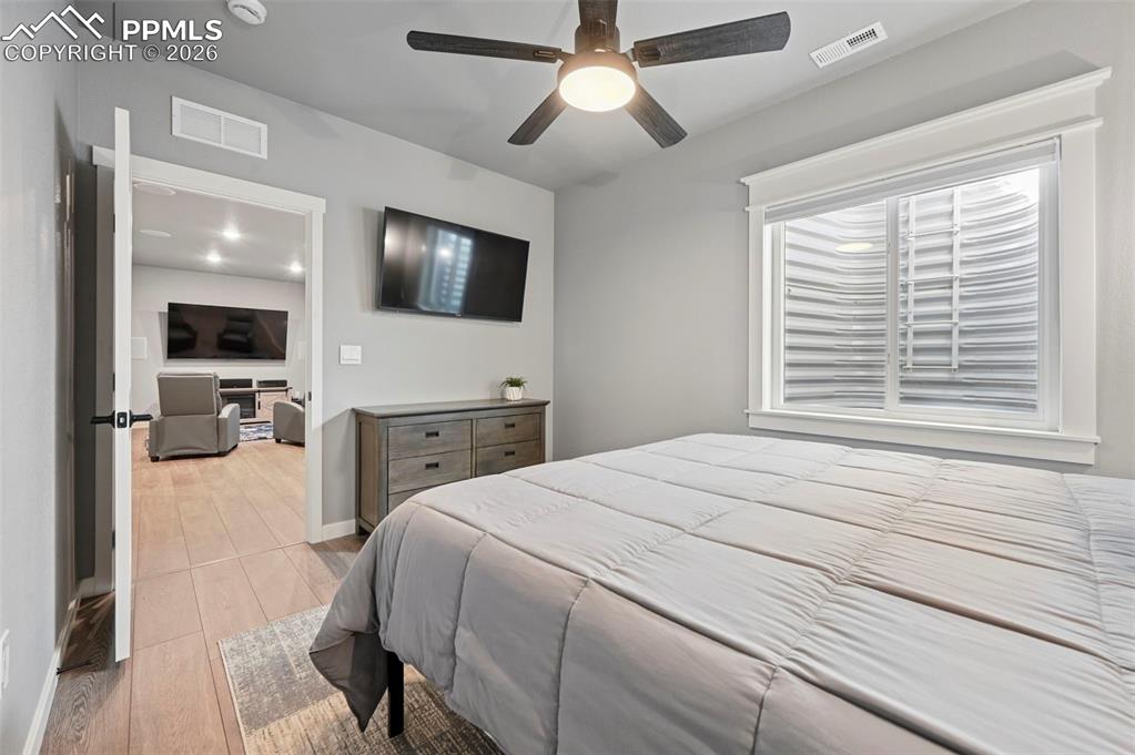 15945 Little Bluestem Road Monument, CO 80132 - Photo 34 of 49 a bedroom with a bed and a flat screen tv