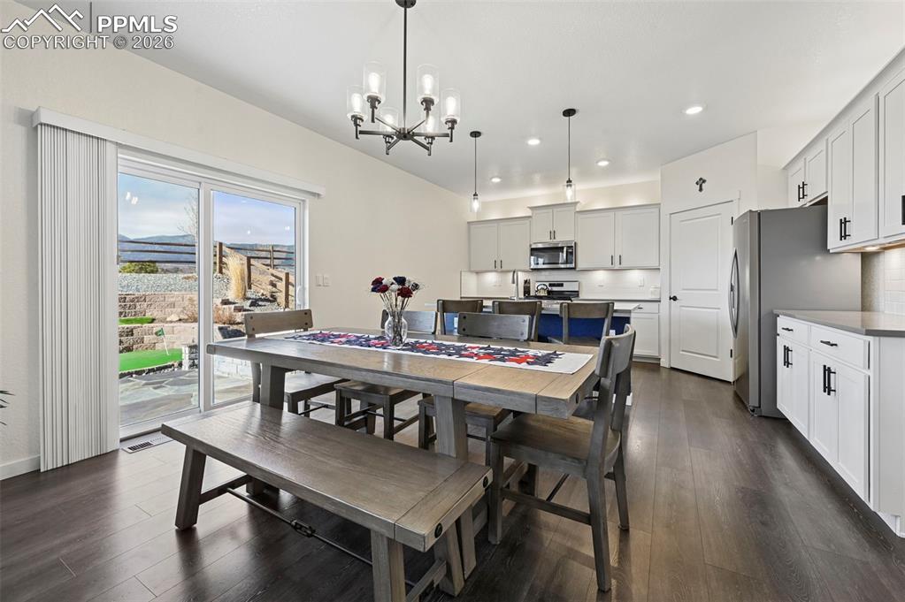 15945 Little Bluestem Road Monument, CO 80132 - Photo 6 of 49 a view of a dining room with furniture window and wooden floor