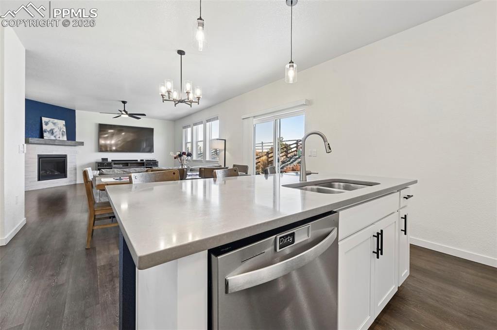 15945 Little Bluestem Road Monument, CO 80132 - Photo 7 of 49 a kitchen with stainless steel appliances granite countertop a sink a stove and a wooden floors