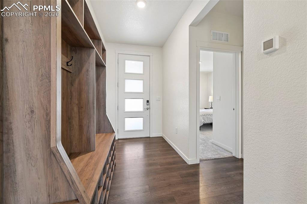 15945 Little Bluestem Road Monument, CO 80132 - Photo 10 of 49 a view of a hallway with wooden floor and stairs