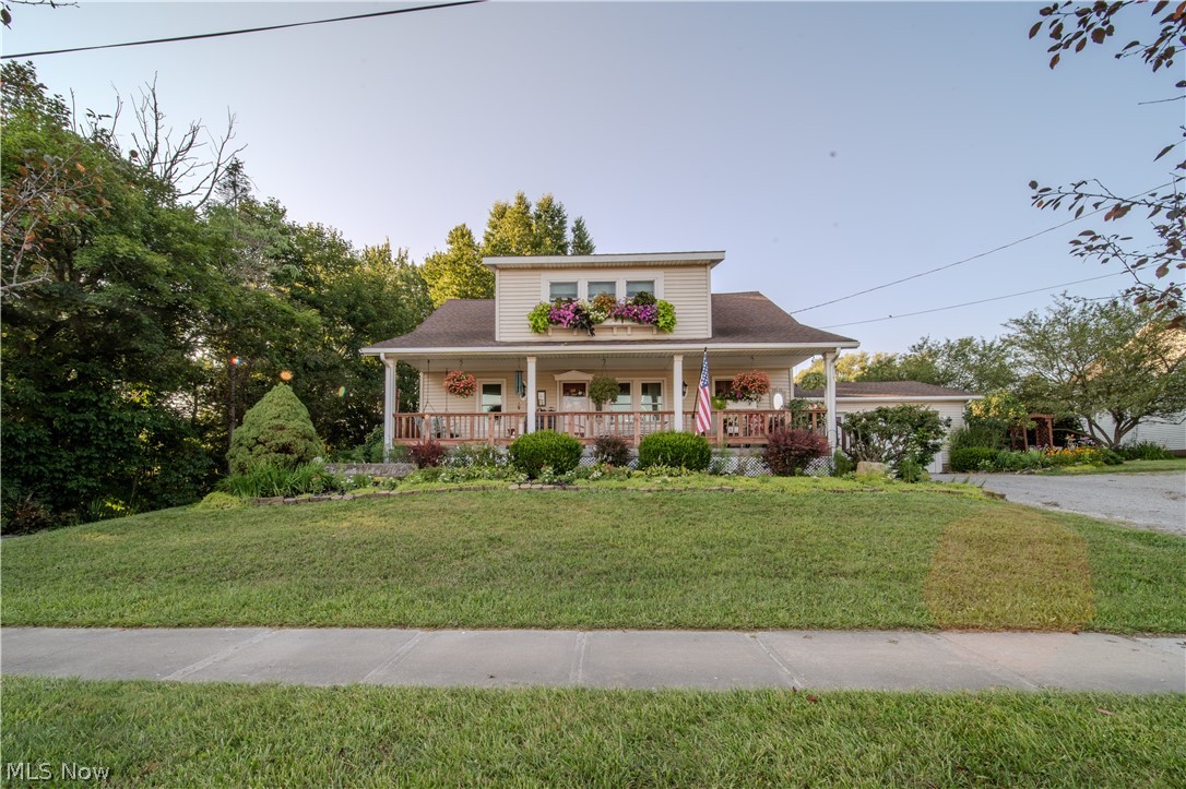 6549 Waterloo Road Atwater, OH 44201 - Photo 1 of 49 Two-story residence featuring a covered front porch with white columns, wood railing, and window boxes