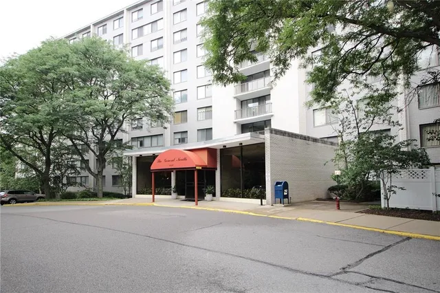 a man walking down a street next to a building