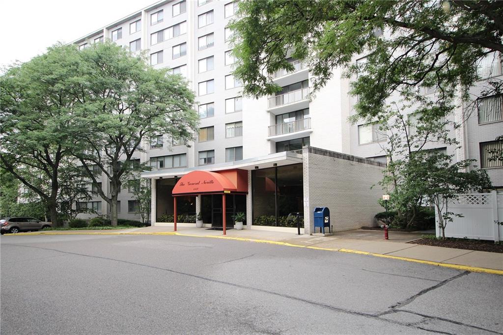 a man walking down a street next to a building