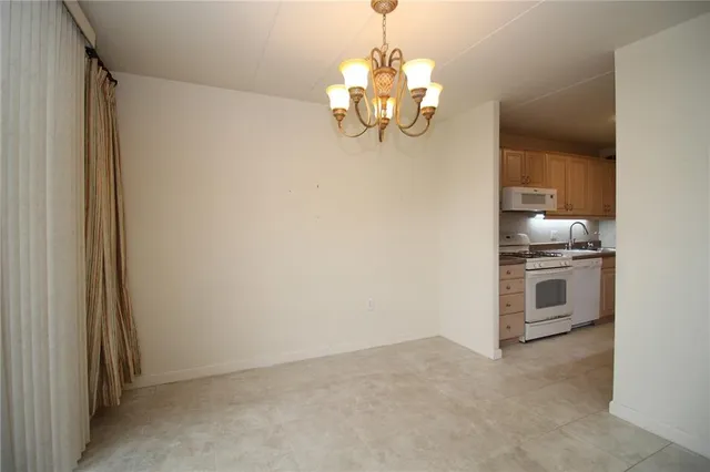 a view of a kitchen with a sink and dishwasher a stove top oven