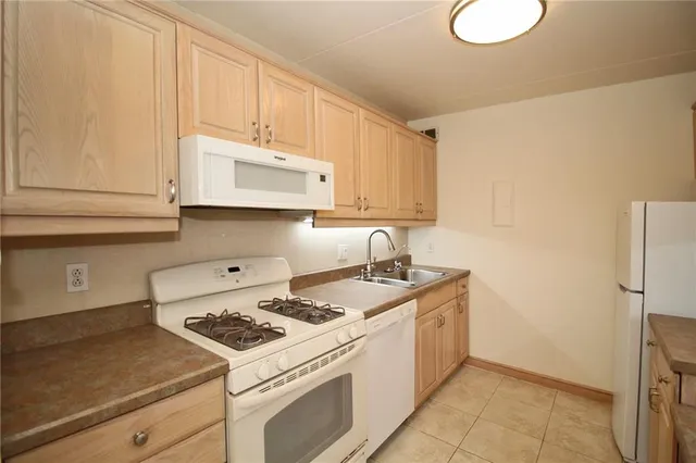 a kitchen with a stove cabinets and a refrigerator