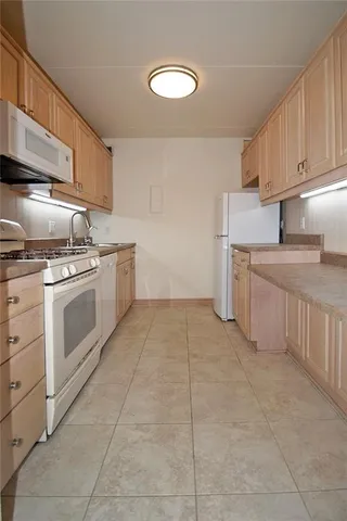 a kitchen with a stove sink and cabinets