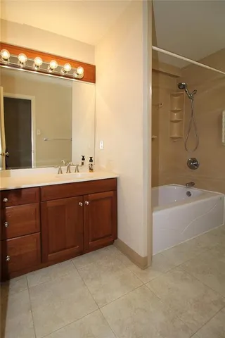 a bathroom with a tub sink toilet and a mirror