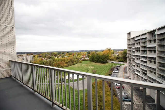 a dining room with furniture and a large window