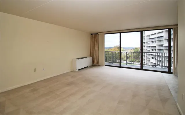 an empty room with windows and city view
