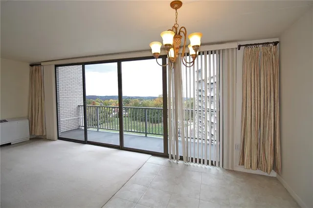 a view of a room with windows and chandelier