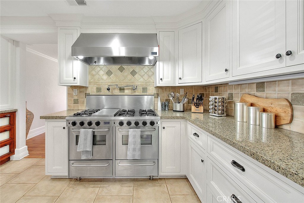 750 Jericho Drive Fallbrook, CA 92028 - Photo 20 of 74 a kitchen with stainless steel appliances granite countertop a stove a sink and white cabinets