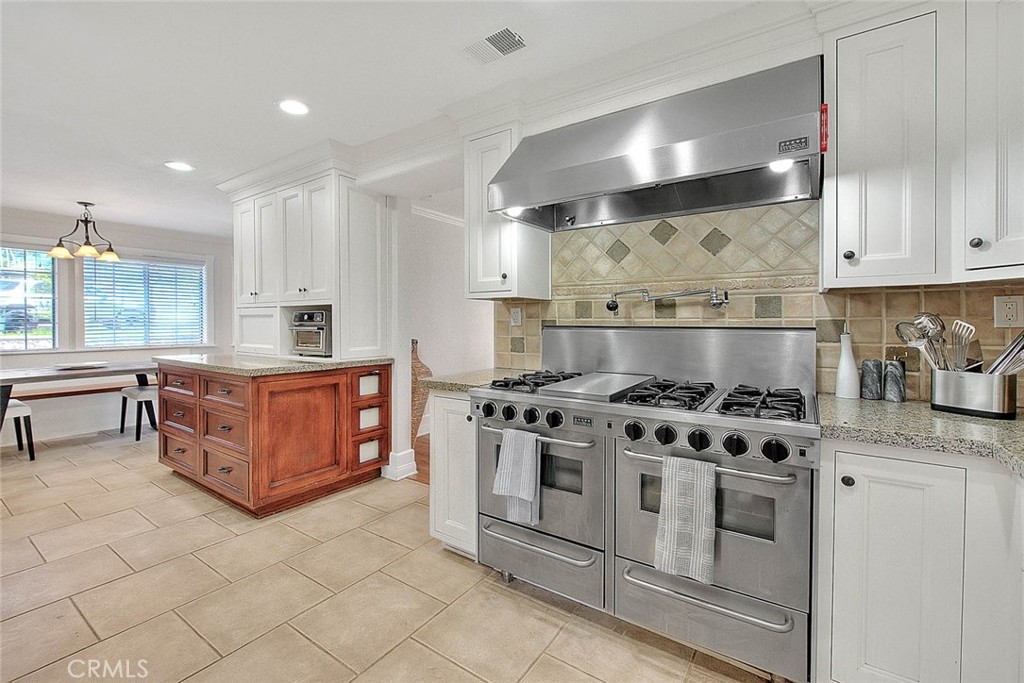 750 Jericho Drive Fallbrook, CA 92028 - Photo 24 of 74 a kitchen with stainless steel appliances granite countertop a stove a sink and a microwave