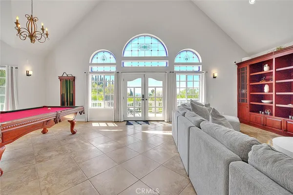 a dining room with furniture a chandelier and wooden floor