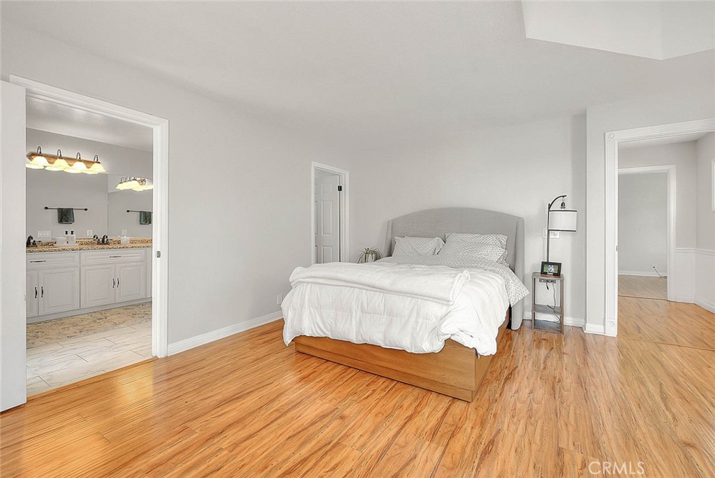 750 Jericho Drive Fallbrook, CA 92028 - Photo 44 of 74 a bedroom with a bed and wooden floor