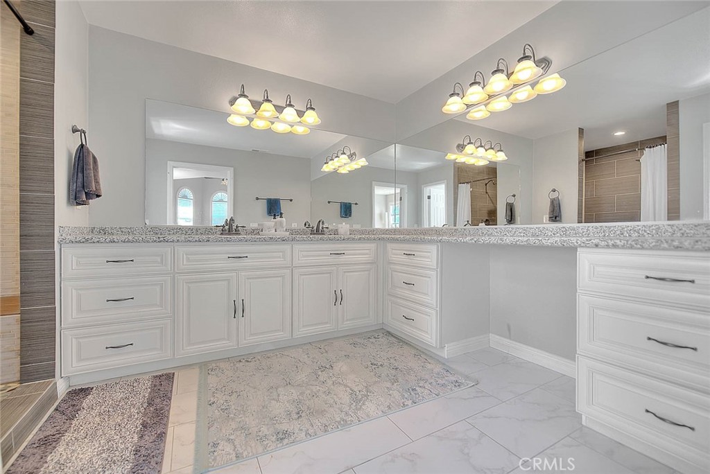 750 Jericho Drive Fallbrook, CA 92028 - Photo 47 of 74 a spacious bathroom with a granite countertop sink a large mirror and a