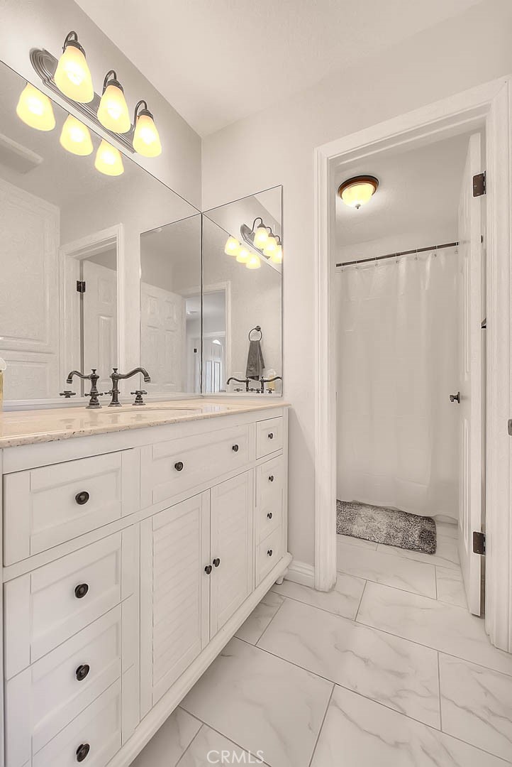 750 Jericho Drive Fallbrook, CA 92028 - Photo 56 of 74 a bathroom with a double vanity sink and a mirror