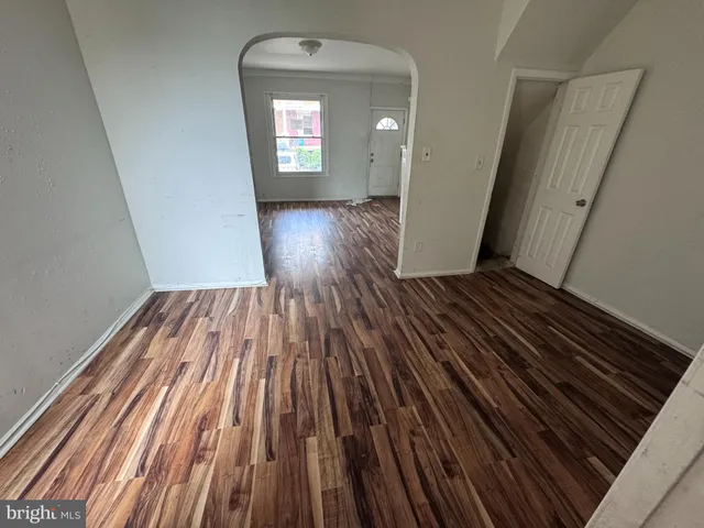 a view of a room with wooden floor