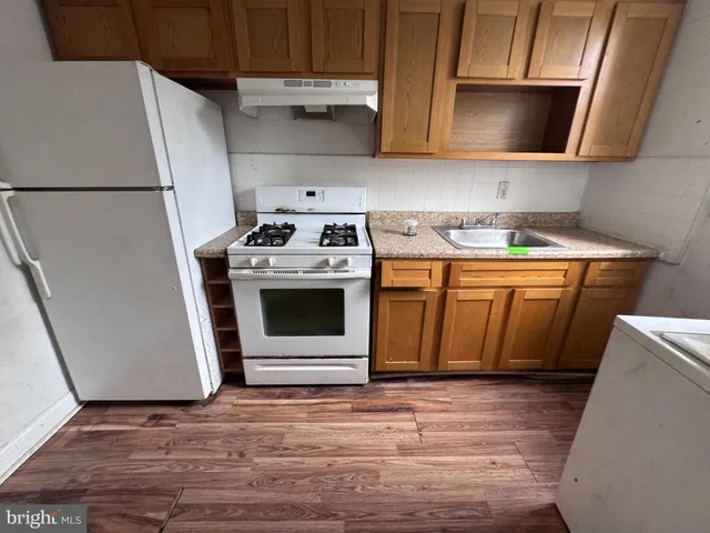 a kitchen with a stove top oven and cabinets