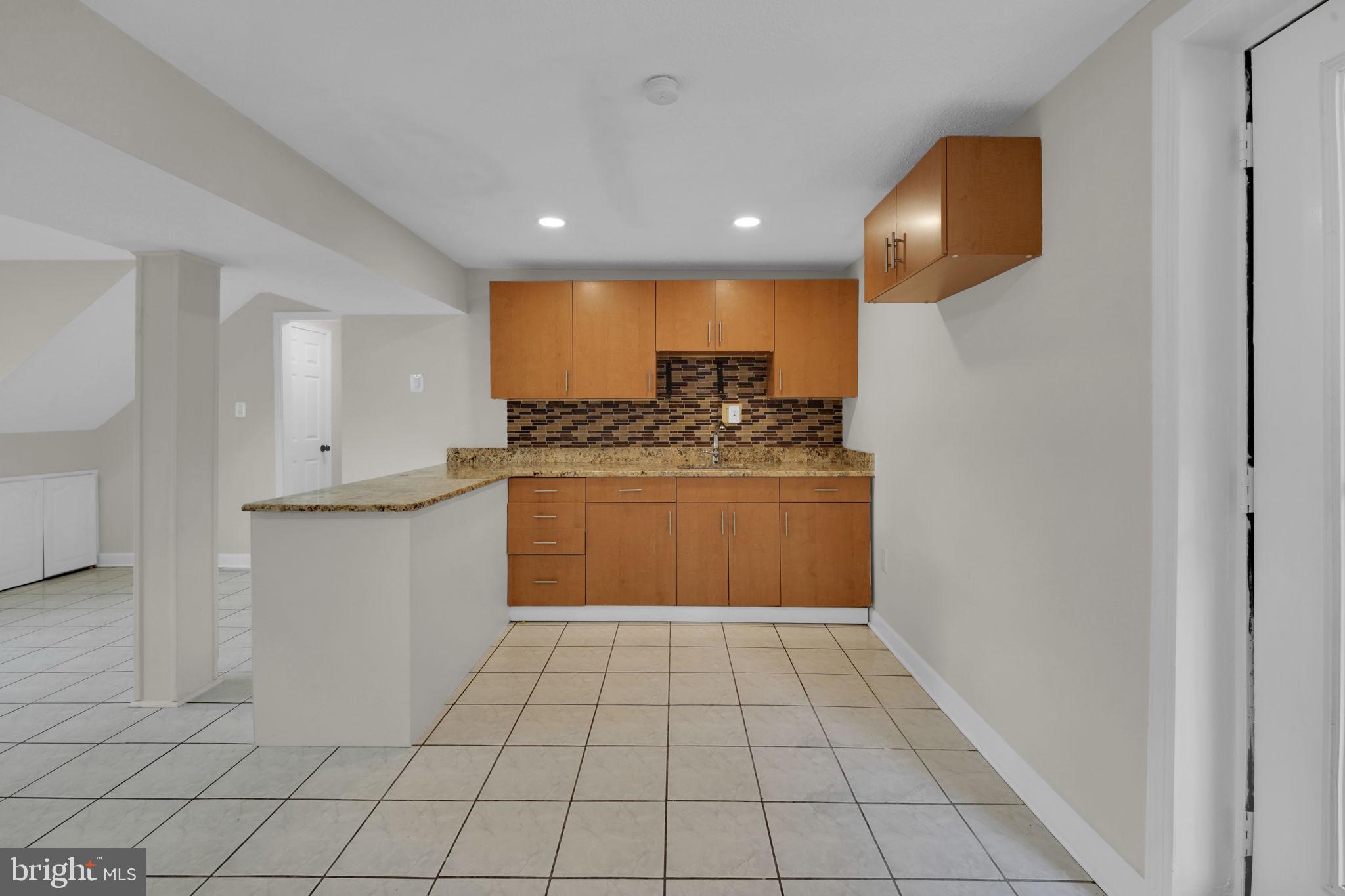 8613 Weems Road Manassas, VA 20110 - Photo 27 of 50 a kitchen with stainless steel appliances granite countertop a sink and cabinets
