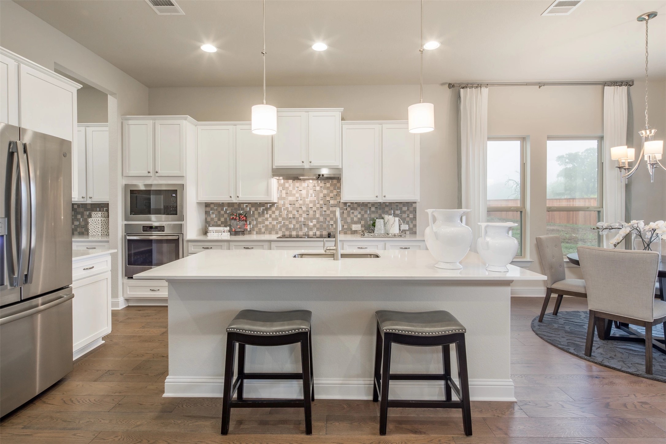 1229 Terrace View Drive Georgetown, TX 78628 - Photo 12 of 17 Culinary delights await in this bright kitchen with a spacious island, premium appliances, and rich wood flooring.