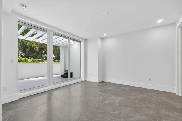 an aerial view of a house with a yard and wooden fence