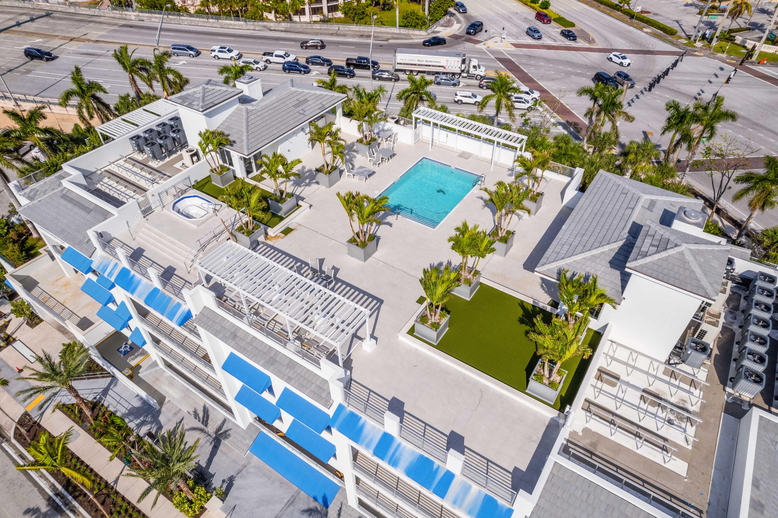 1 South Coastal Way, Unit 205 Jupiter, FL 33477 - Photo 29 of 67 an aerial view of a house with a yard and wooden fence