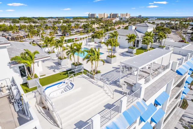 a view of a city with lots of residential buildings and ocean view in back