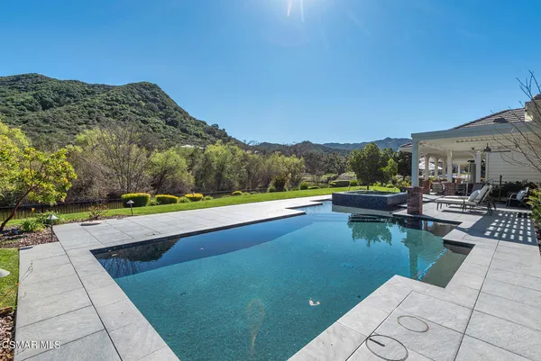 a view of swimming pool with a patio