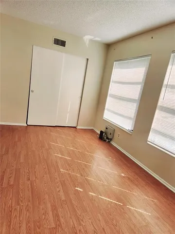 a view of a room with wooden floor and white walls