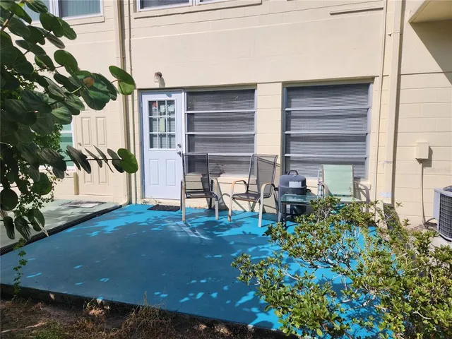 a view of a chairs and table in the patio