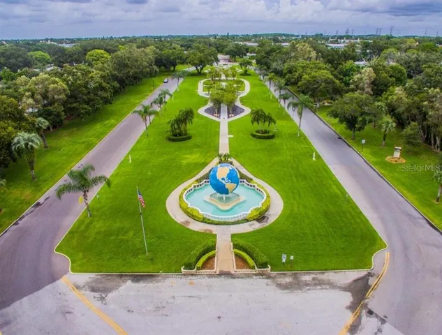 a swimming pool with plants and large trees