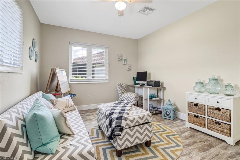 148 Pebble Beach Boulevard Naples, FL 34113 - Photo 13 of 24 a bedroom with a bed and furniture