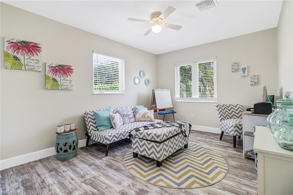 148 Pebble Beach Boulevard Naples, FL 34113 - Photo 14 of 24 a living room with furniture and a window