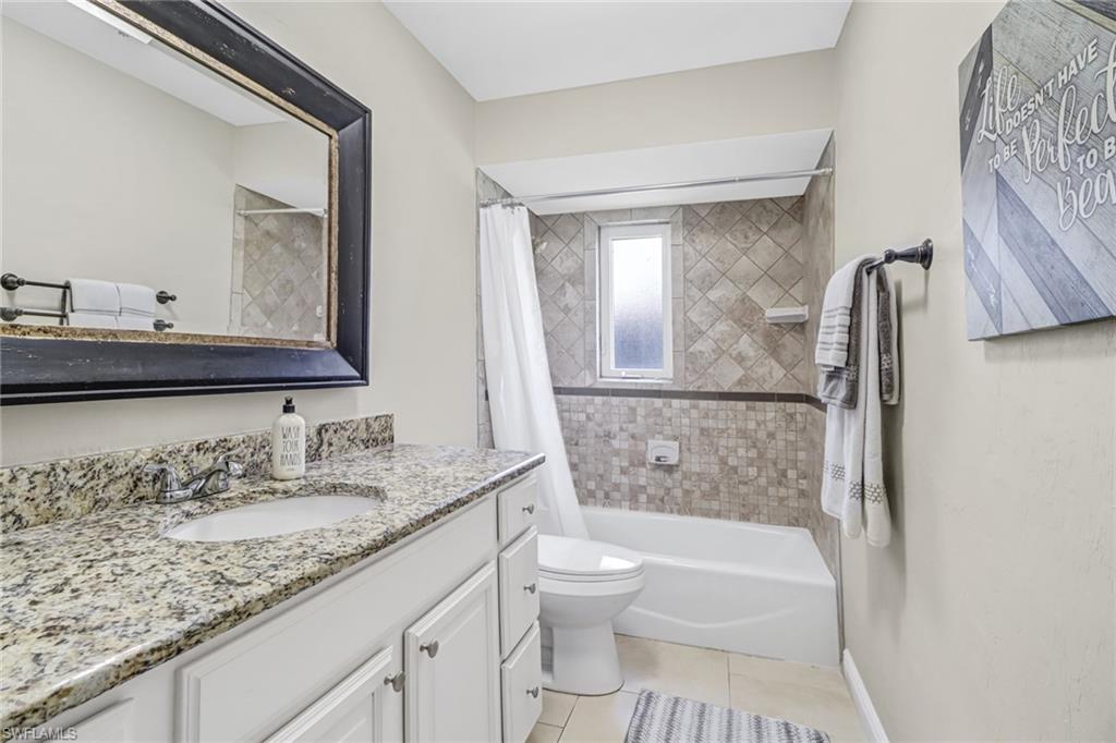 148 Pebble Beach Boulevard Naples, FL 34113 - Photo 15 of 24 a bathroom with a granite countertop sink toilet and shower