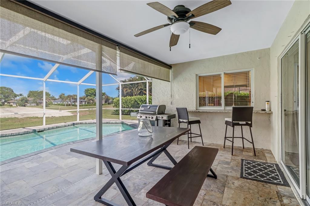 148 Pebble Beach Boulevard Naples, FL 34113 - Photo 18 of 24 a view of a livingroom with furniture and a floor to ceiling window
