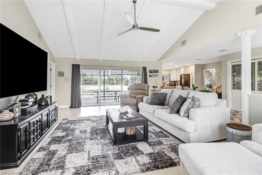 148 Pebble Beach Boulevard Naples, FL 34113 - Photo 2 of 24 a living room with furniture and a flat screen tv