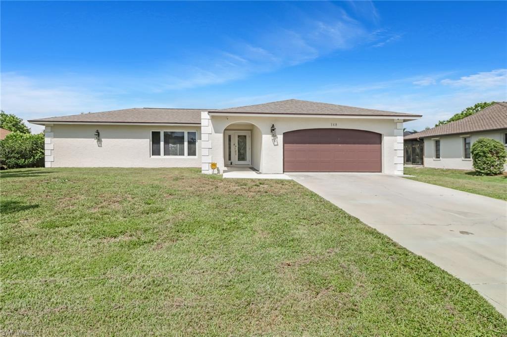 148 Pebble Beach Boulevard Naples, FL 34113 - Photo 24 of 24 a front view of a house with yard and garage