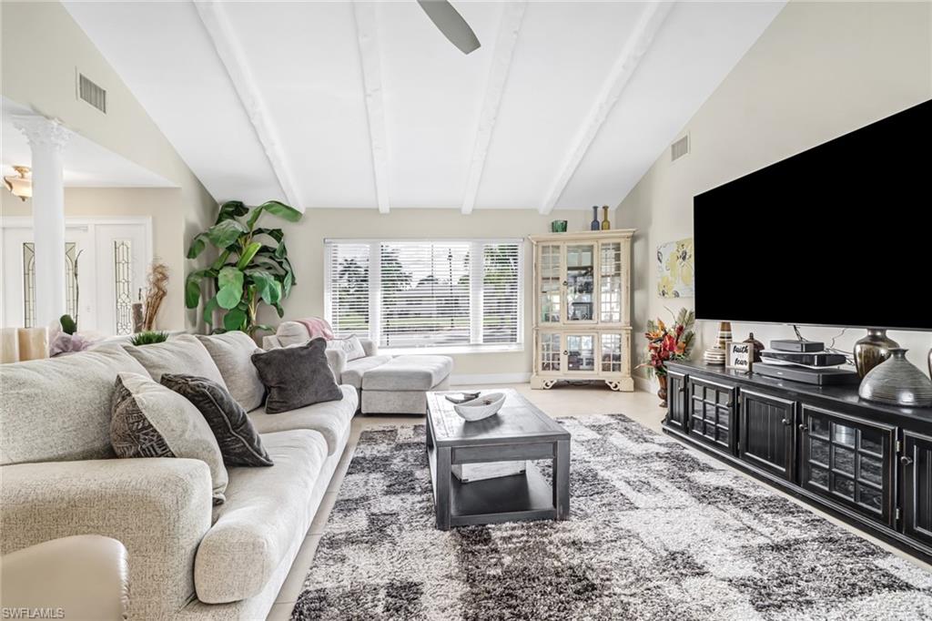 148 Pebble Beach Boulevard Naples, FL 34113 - Photo 4 of 24 a living room with furniture and a flat screen tv
