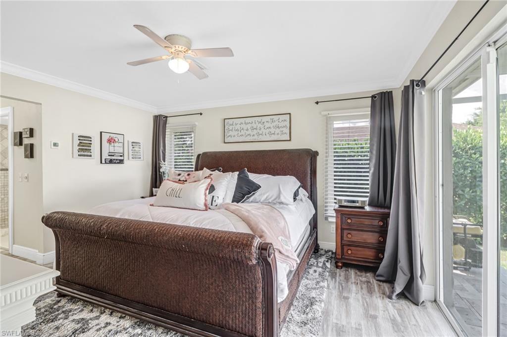 148 Pebble Beach Boulevard Naples, FL 34113 - Photo 9 of 24 a bedroom with a bed and a window