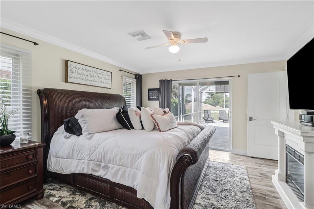 148 Pebble Beach Boulevard Naples, FL 34113 - Photo 10 of 24 a bedroom with a bed and a flat screen tv