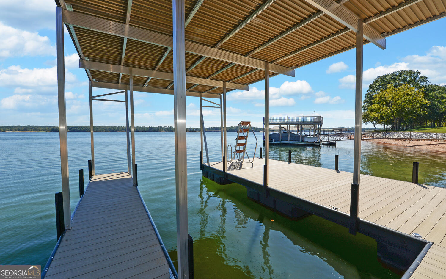 a view of a balcony with lake view and wooden floor