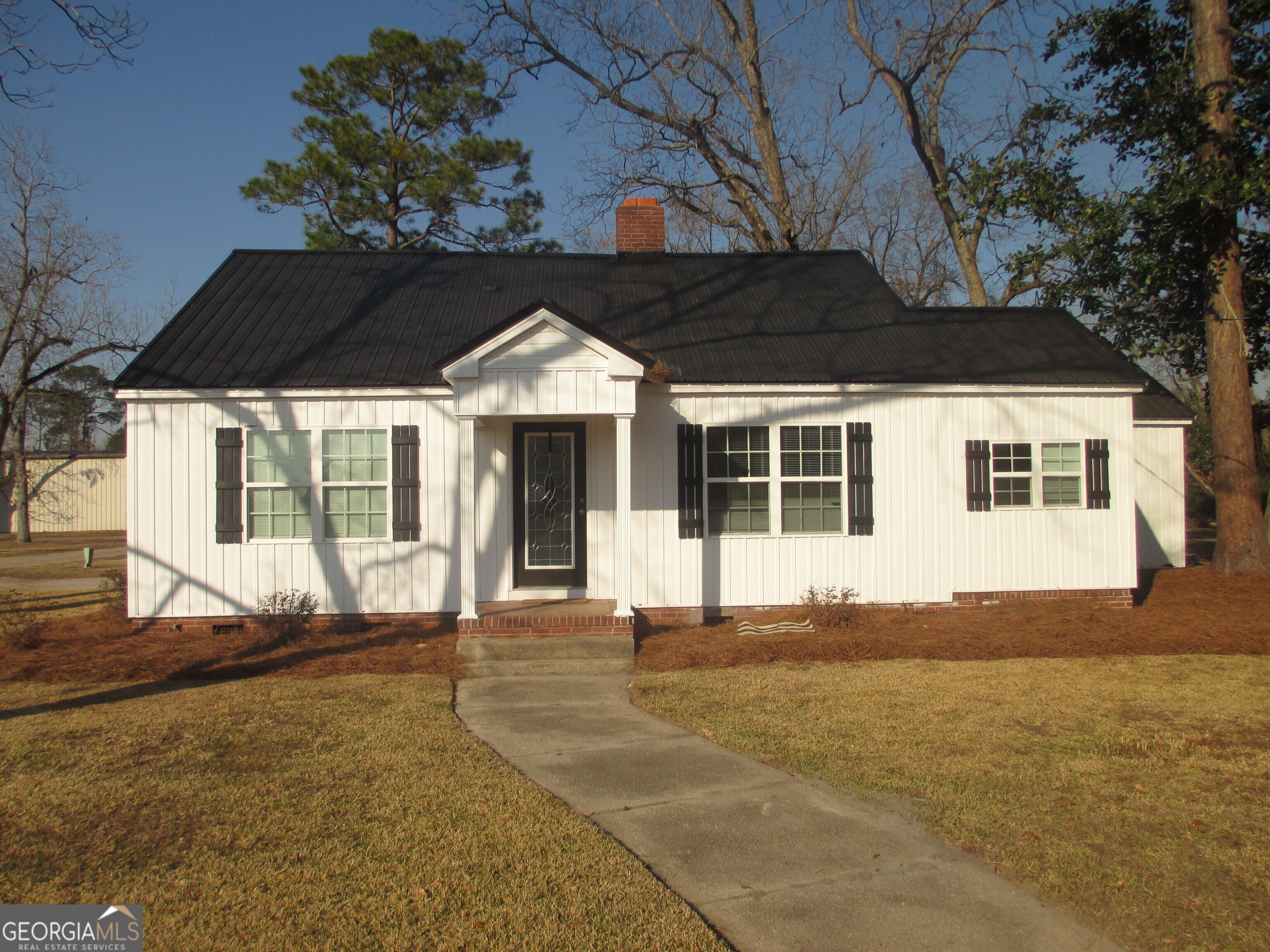 390 Bay Street Baxley, GA 31513 - Photo 1 of 24 a front view of a house with a large window