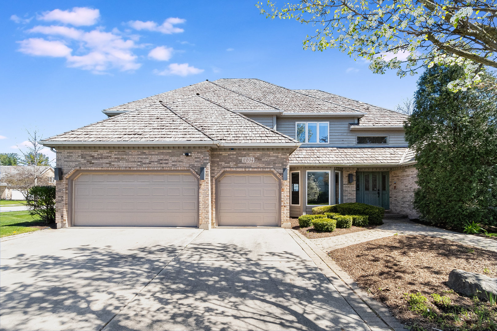 2204 Arrowhead Drive Naperville, IL 60564 - Photo 1 of 40 a front view of a house with a yard and garage