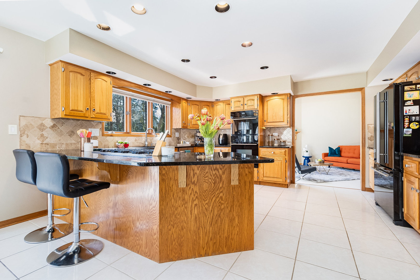 2204 Arrowhead Drive Naperville, IL 60564 - Photo 13 of 40 a kitchen with stainless steel appliances kitchen island granite countertop a table and chairs in it