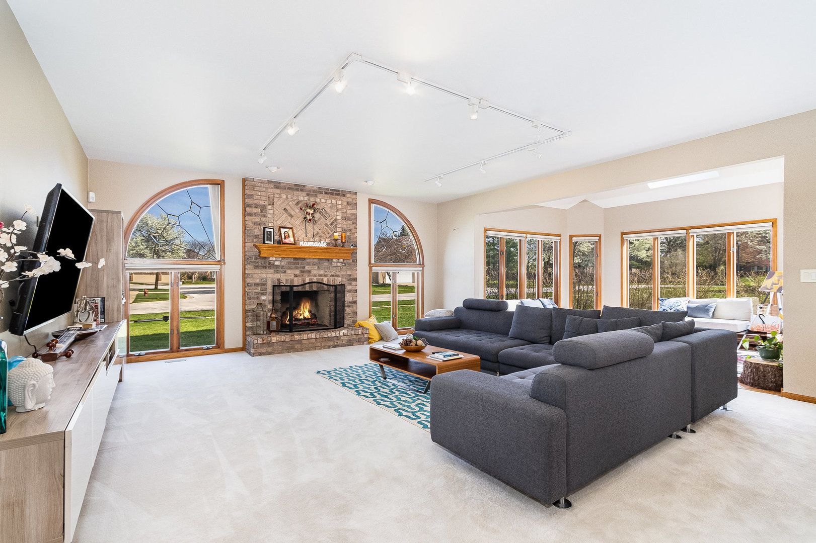 2204 Arrowhead Drive Naperville, IL 60564 - Photo 14 of 40 a living room with furniture a fireplace and a flat screen tv
