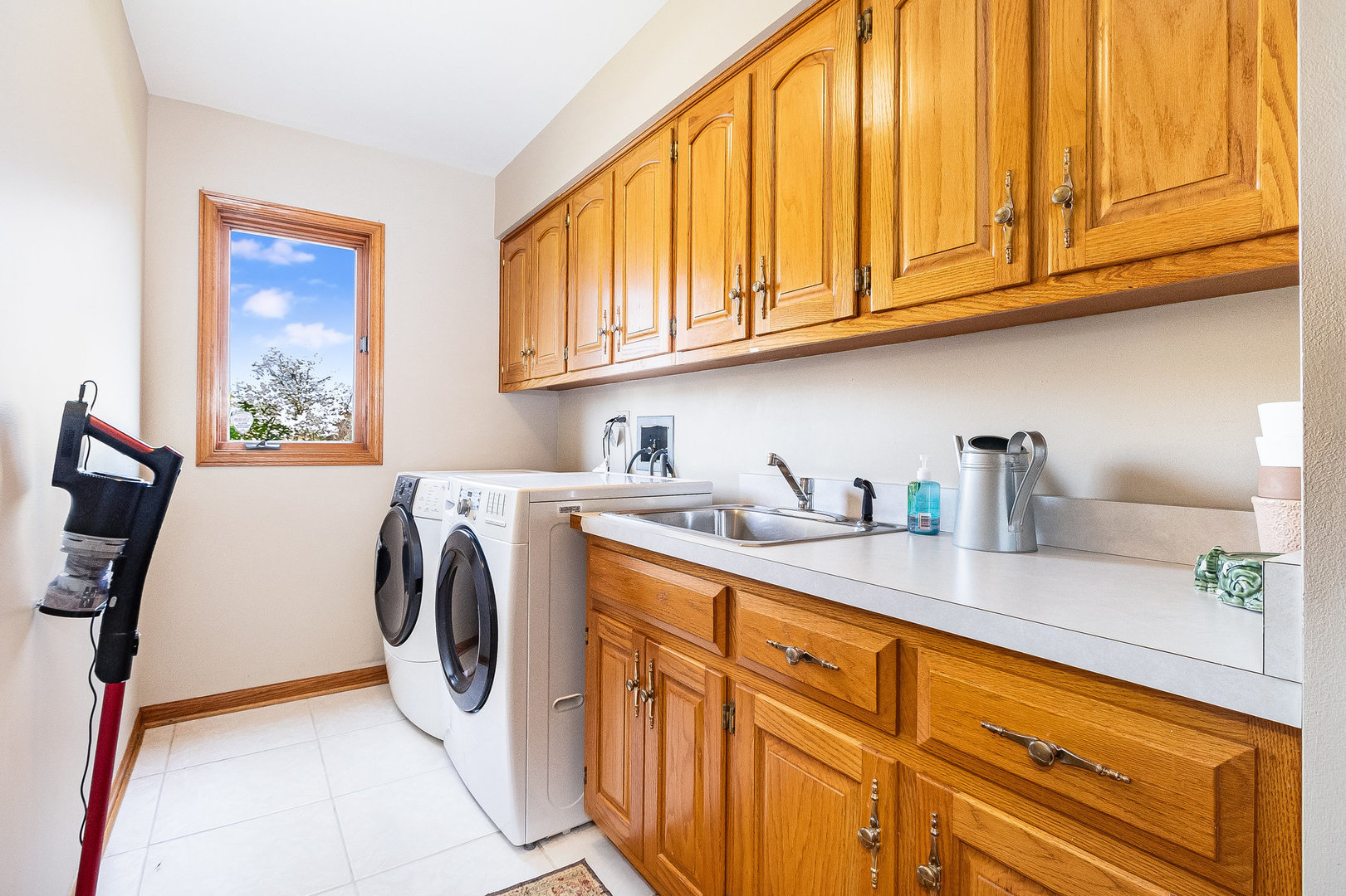 2204 Arrowhead Drive Naperville, IL 60564 - Photo 20 of 40 a utility room with stainless steel appliances granite countertop a sink a washer and dryer next to a window