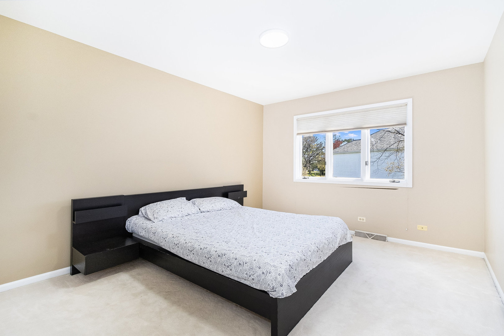 2204 Arrowhead Drive Naperville, IL 60564 - Photo 27 of 40 a bedroom with a bed and a window