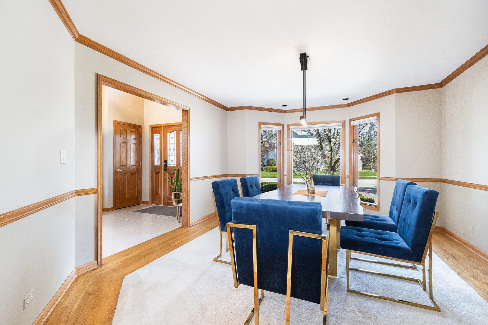 2204 Arrowhead Drive Naperville, IL 60564 - Photo 9 of 40 a dining room with furniture a chandelier and wooden floor