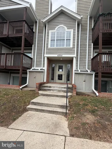 a view of a house with a large window and wooden floor